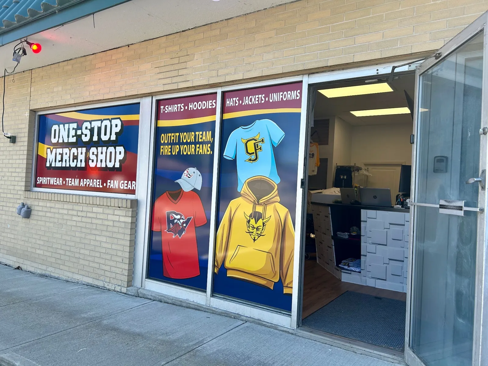 Storefront of the T Shirts in 24 One-Stop Merch Shop in Old Forge, PA with door open