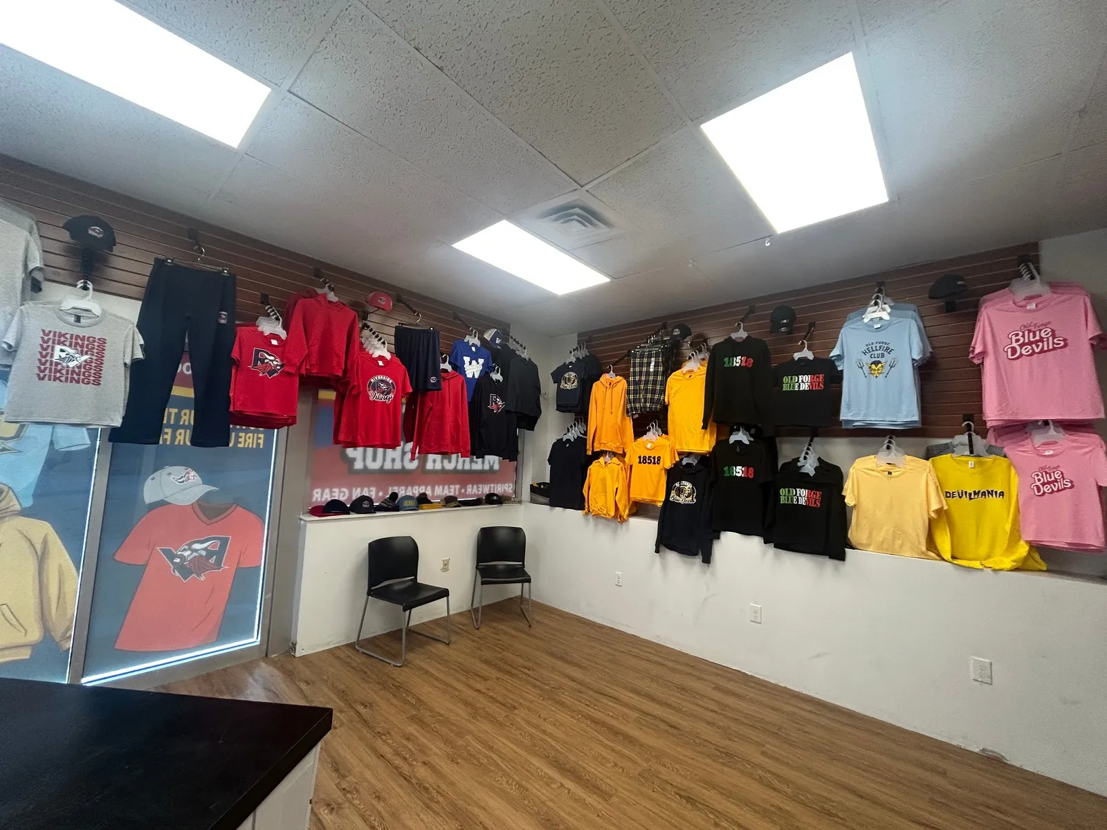 Interior of the T Shirts in 24 merch shop with spirit wear on display