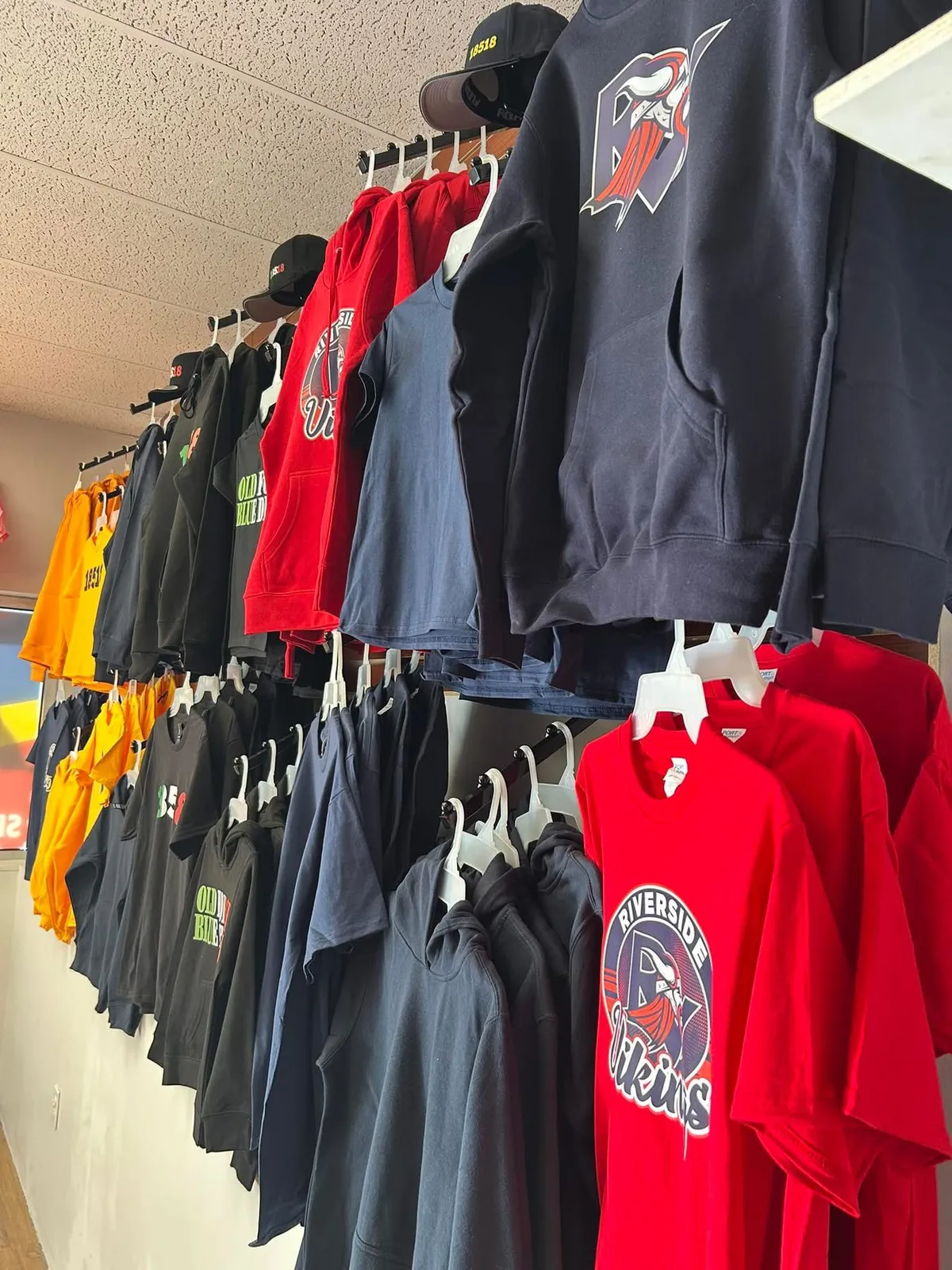 Racks of Riverside Vikings and Old Forge Blue Devils hoodies and tees