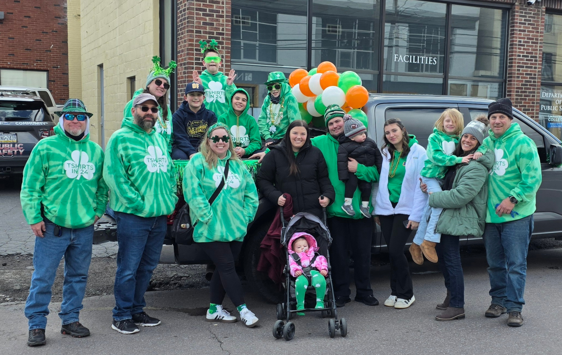 T Shirts in 24 crew and families in matching green tie-dye TShirts In 24 hoodies at the St. Patrick's Day parade